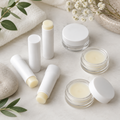 Simply Lip Balm sticks and jars in white packaging with pale yellow balm